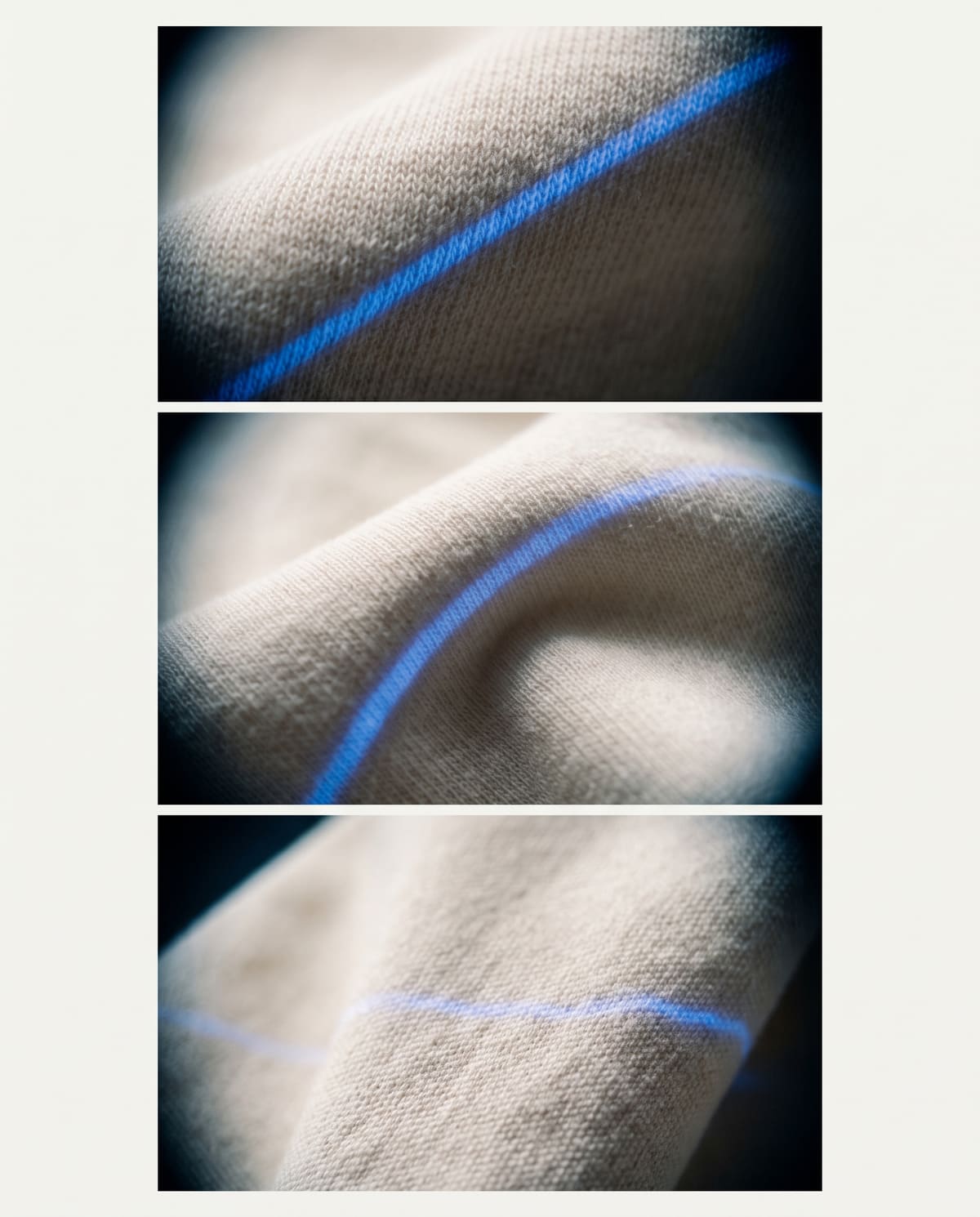 Macro of cotton jersey knit under a thin band of cobalt light